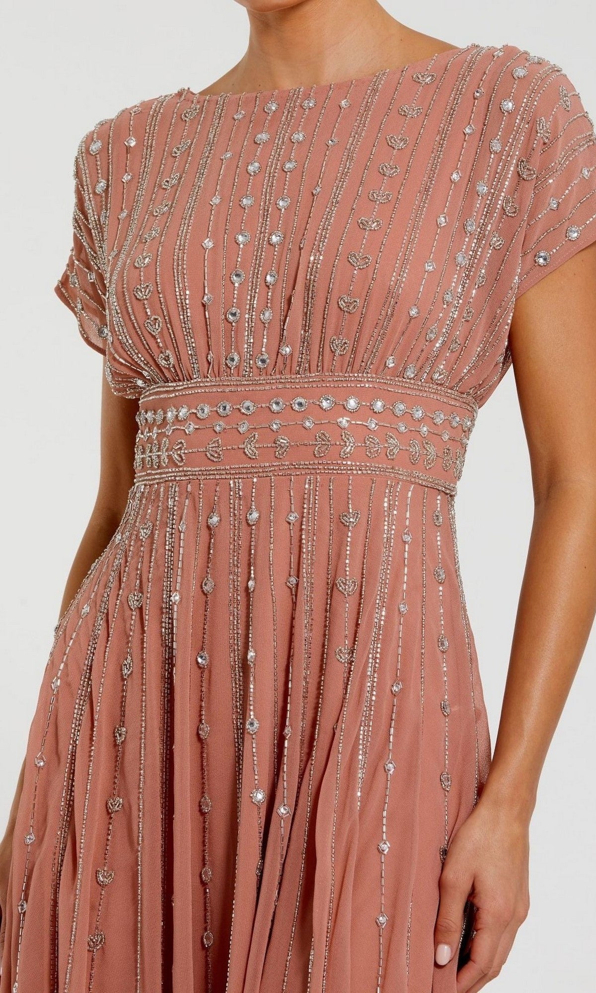 A woman wears the Midi Party Dress: Mac Duggal 94153, a pink gown embellished with silver beads and sequins in vertical and leaf patterns, exuding the elegance of a beaded midi dress.